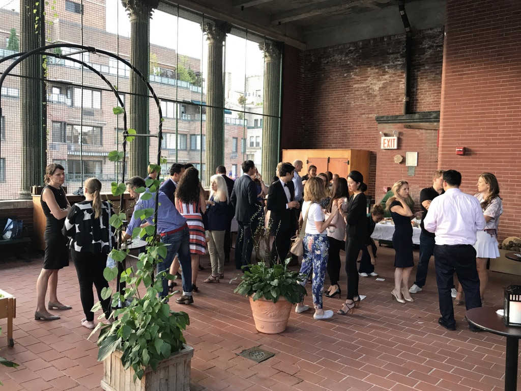 parents mingling at a party on the rooftop playground