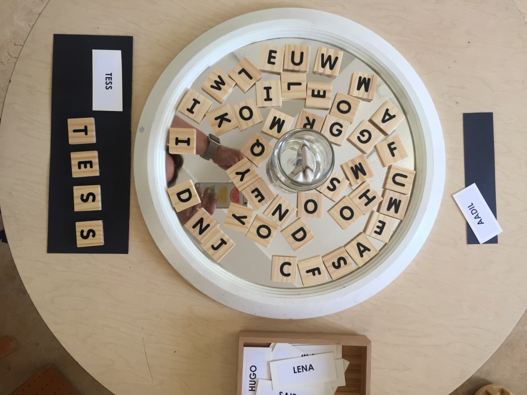 scrabble pieces used to spell children's names
